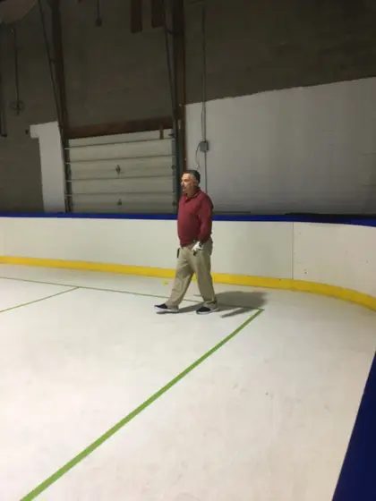 A player walking across the pickleball court